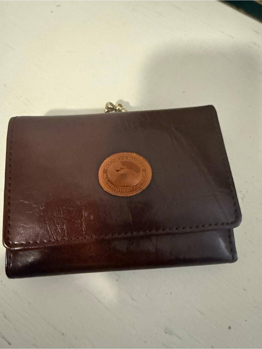 Dooney and Bourke vintage brown leather trifold wallet with kiss lock coin